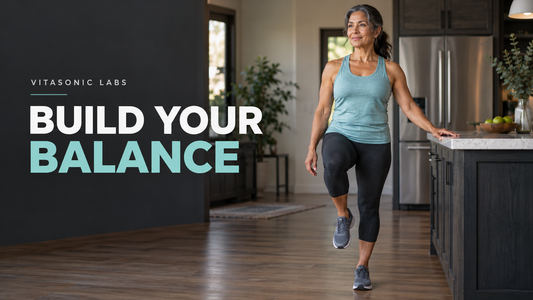 Vitasonic Labs Build Your Balance banner showing a woman practicing a supported single-leg stand by a sturdy countertop.