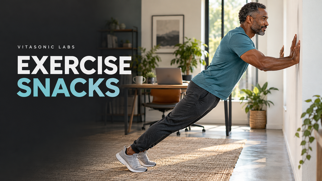 Vitasonic Labs Exercise Snacks banner showing a man taking a brief wall push-up break in a home office.