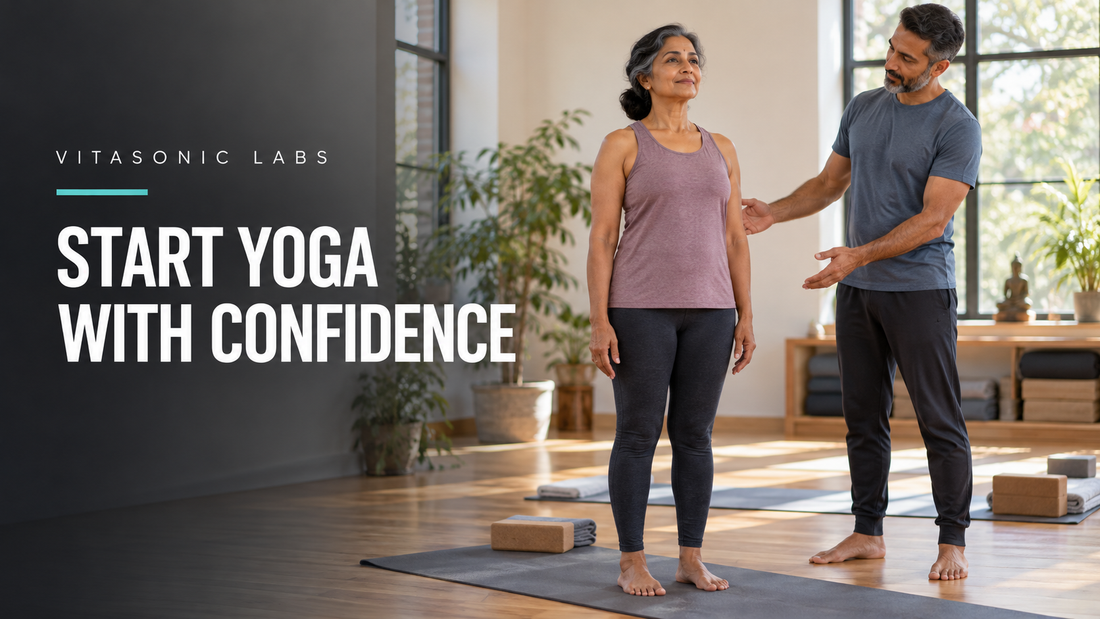 Vitasonic Labs beginner yoga banner with an adult woman standing on a mat beside an instructor in a bright studio.